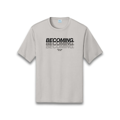 Gray t-shirt with 'BECOMING' text printed multiple times on a silver background